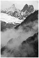 Inspiration Peak and the Pyramid rising above clouds, North Cascades National Park. Washington, USA. (black and white)