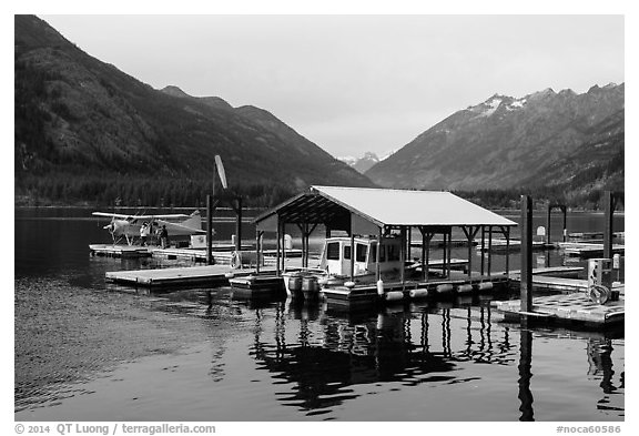 Fuel pump, boat, and floatplane, Stehekin, North Cascades National Park Service Complex.  (black and white)