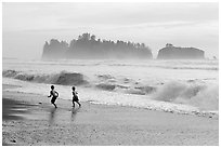 Children running along surf, Rialto Beach. Olympic National Park, Washington, USA. (black and white)