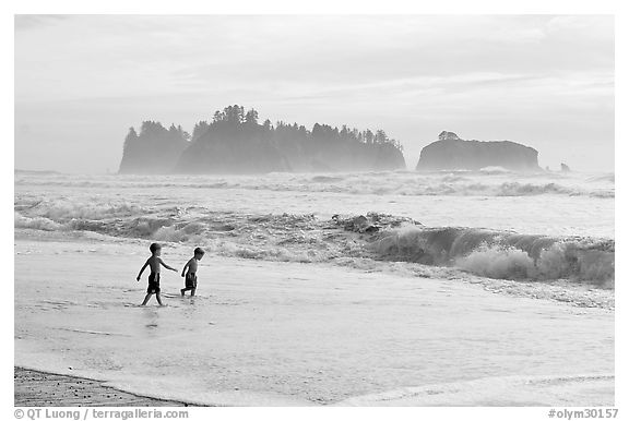 Children playing in water in front of sea stacks, Rialto Beach. Olympic National Park (black and white)