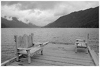 Two chairs on pier, Crescent Lake. Olympic National Park, Washington, USA. (black and white)