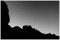 Rocky ridge and stars at twilight. Pinnacles National Park, California, USA. (black and white)