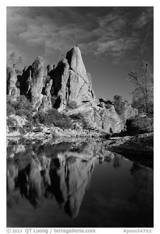 Climber standing on spire next to Bear Gulch Reservoir. Pinnacles National Park, California, USA.