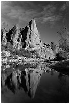 Climber standing on spire next to Bear Gulch Reservoir. Pinnacles National Park, California, USA. (black and white)