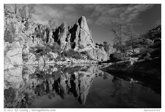 Spire and reflection in glassy water, Bear Gulch Reservoir. Pinnacles National Park, California, USA.