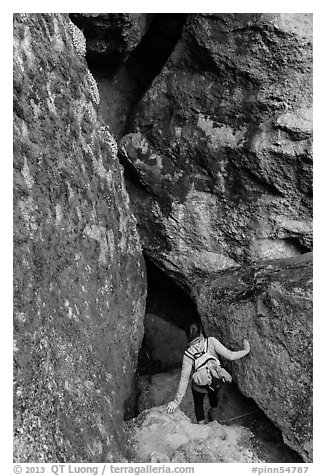 Woman walking into Balconies Cave. Pinnacles National Park, California, USA.