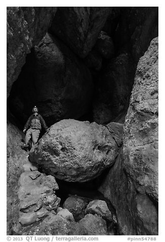 Man with headlamp looking up in Balconies Cave. Pinnacles National Park (black and white)