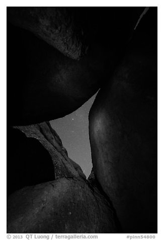 Night sky seen through opening between boulders. Pinnacles National Park (black and white)