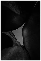 Night sky seen through opening between boulders. Pinnacles National Park ( black and white)