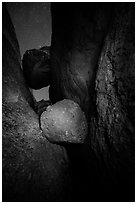 Boulders wedged in Balconies Cave at night. Pinnacles National Park, California, USA. (black and white)