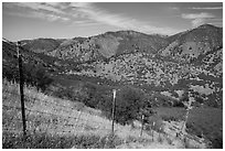 Boundary fence along steep hill. Pinnacles National Park, California, USA. (black and white)