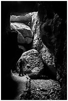 Hiker looking around Bear Gulch Cave. Pinnacles National Park ( black and white)