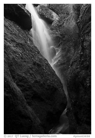 Waterfall spilling down from reservoir into Bear Gulch Cave. Pinnacles National Park (black and white)