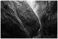 Bear Gulch Cave mossy rocks with waterfall from reservoir. Pinnacles National Park ( black and white)