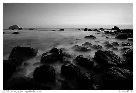 Boulders and ocean at dusk, False Klamath cove. Redwood National Park, California, USA.