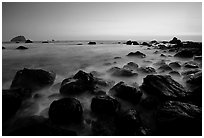 Boulders and ocean at dusk, False Klamath cove. Redwood National Park, California, USA. (black and white)