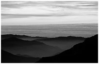Receding lines of  foothills and sea of clouds at sunset. Sequoia National Park, California, USA. (black and white)