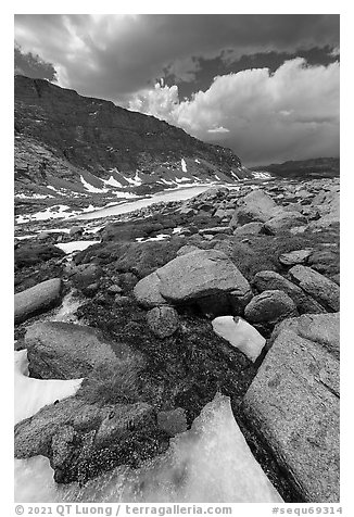 Alpine stream flowing from beneath ice. Sequoia National Park (black and white)
