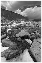 Alpine stream flowing from beneath ice. Sequoia National Park ( black and white)