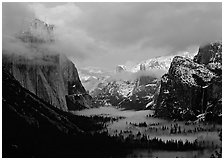 View with fog in valley and peaks lighted by sunset, winter. Yosemite National Park, California, USA. (black and white)