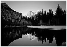 Half-Dome reflected in Merced River near Sentinel Bridge, sunset. Yosemite National Park, California, USA. (black and white)