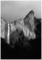 Bridalveil Falls and Leaning Tower, stormy sky. Yosemite National Park, California, USA. (black and white)