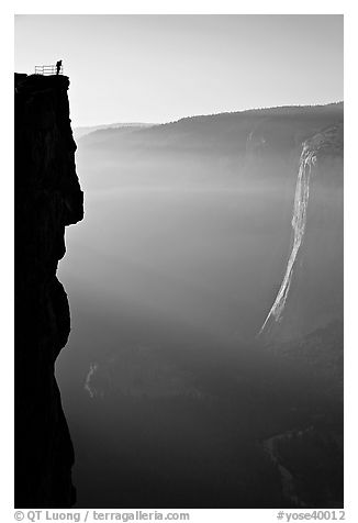 Hiker surveying Yosemite Valley from Profile Cliff overlook. Yosemite National Park, California, USA.