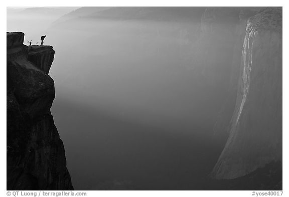 Hiker looking down Yosemite Valley from Taft point at sunset. Yosemite National Park (black and white)