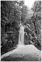 Snow-covered boulder and base of Chilnualna Falls. Yosemite National Park, California, USA. (black and white)