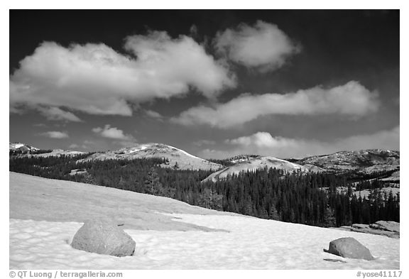 Snow on slab, boulders, and distant domes, Tuolumne Meadows. Yosemite National Park, California, USA.