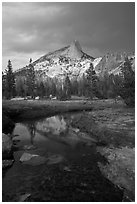 Cathedral Peak reflected in stream under stormy skies. Yosemite National Park, California, USA. (black and white)