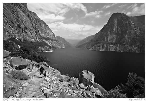 Father hiking with boy next to Hetch Hetchy reservoir. Yosemite National Park (black and white)