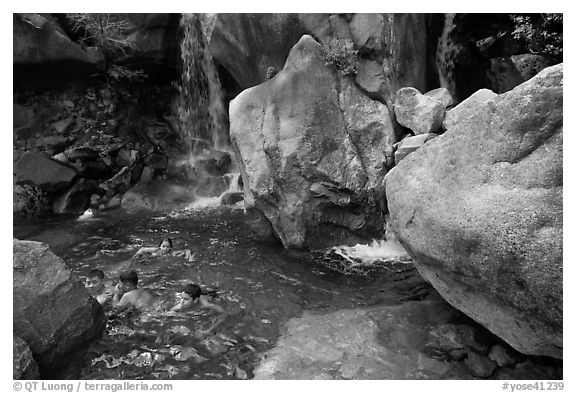 Children swimming in pool at the base of Wapama falls. Yosemite National Park, California, USA.