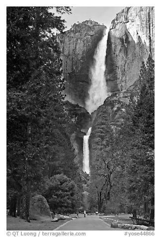 Tourists on path dwarfed by Upper and Lower Yosemite Falls. Yosemite National Park (black and white)