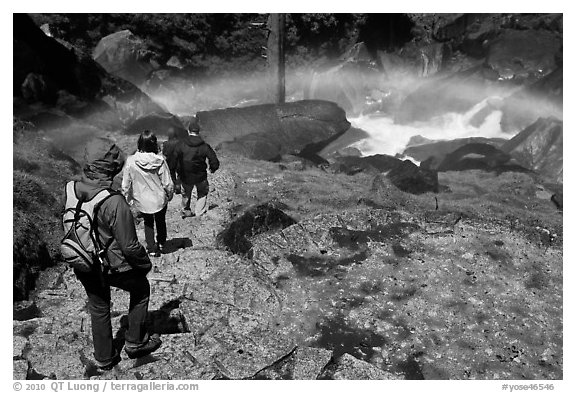 Hikers walking through rainbow, Mist Trail. Yosemite National Park (black and white)