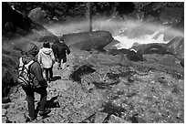 Hikers walking through rainbow, Mist Trail. Yosemite National Park, California, USA. (black and white)