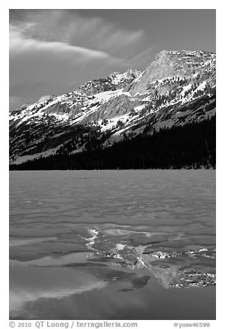 Peak reflected in thawing Tenaya Lake. Yosemite National Park, California, USA.