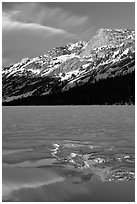 Peak reflected in thawing Tenaya Lake. Yosemite National Park, California, USA. (black and white)