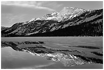 Tenaya Peak reflected in partly iced Tenaya Lake. Yosemite National Park, California, USA. (black and white)