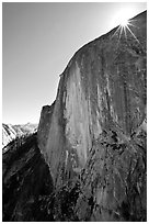Sunburst at the top of Half-Dome face. Yosemite National Park, California, USA. (black and white)