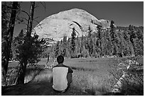 Hiker looking at backside of Half-Dome from Lost Lake. Yosemite National Park ( black and white)