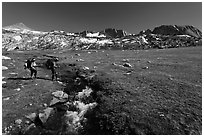 Backpackers crossing stream, Evelyn Lake. Yosemite National Park, California, USA. (black and white)