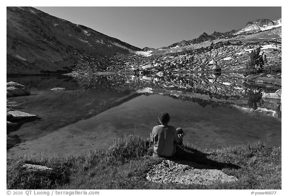 Hiker sitting by alpine lake, Vogelsang. Yosemite National Park (black and white)