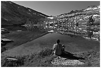 Hiker sitting by alpine lake, Vogelsang. Yosemite National Park ( black and white)