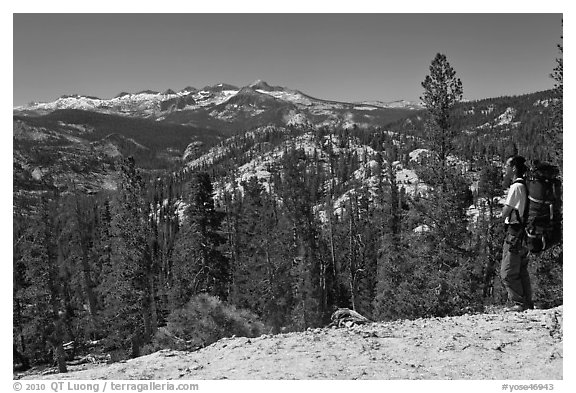 Backpacker surveying high country from Cathedral Pass. Yosemite National Park (black and white)