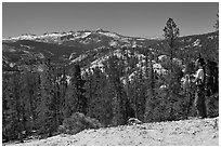 Backpacker surveying high country from Cathedral Pass. Yosemite National Park, California, USA. (black and white)