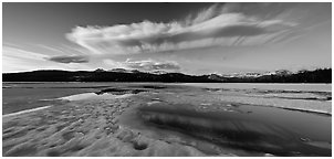 Snow-covered Twolumne Meadows and big cloud at sunset. Yosemite National Park, California, USA. (black and white)