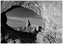 Turret Arch seen through South Window, sunrise. Arches National Park, Utah, USA. (black and white)