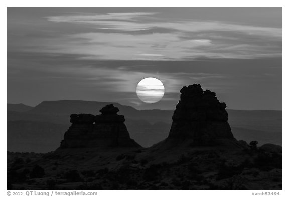 Sun setting between rock towers. Arches National Park (black and white)