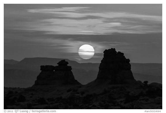 Sun setting between rock towers. Arches National Park, Utah, USA.